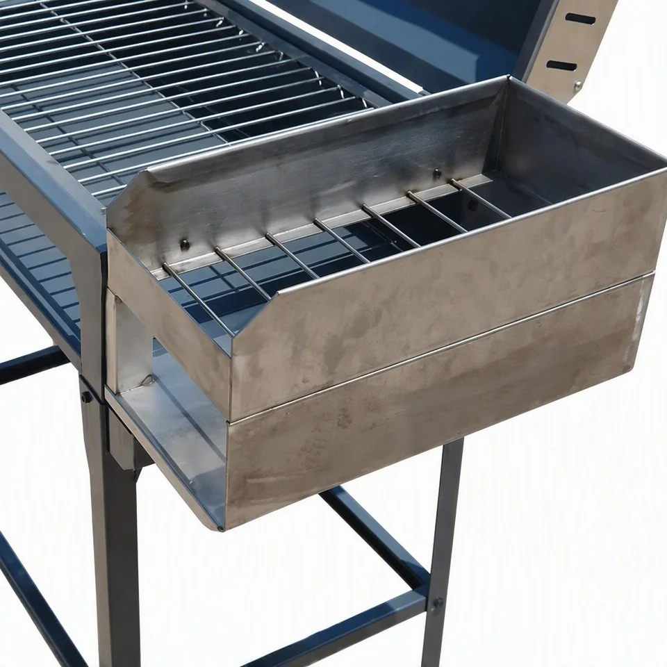 Chulenguito charcoal BBQ grill stainless steel side firebox with charcoal rack close up